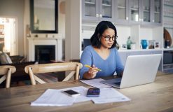 Shot of a young woman using a laptop while working from home